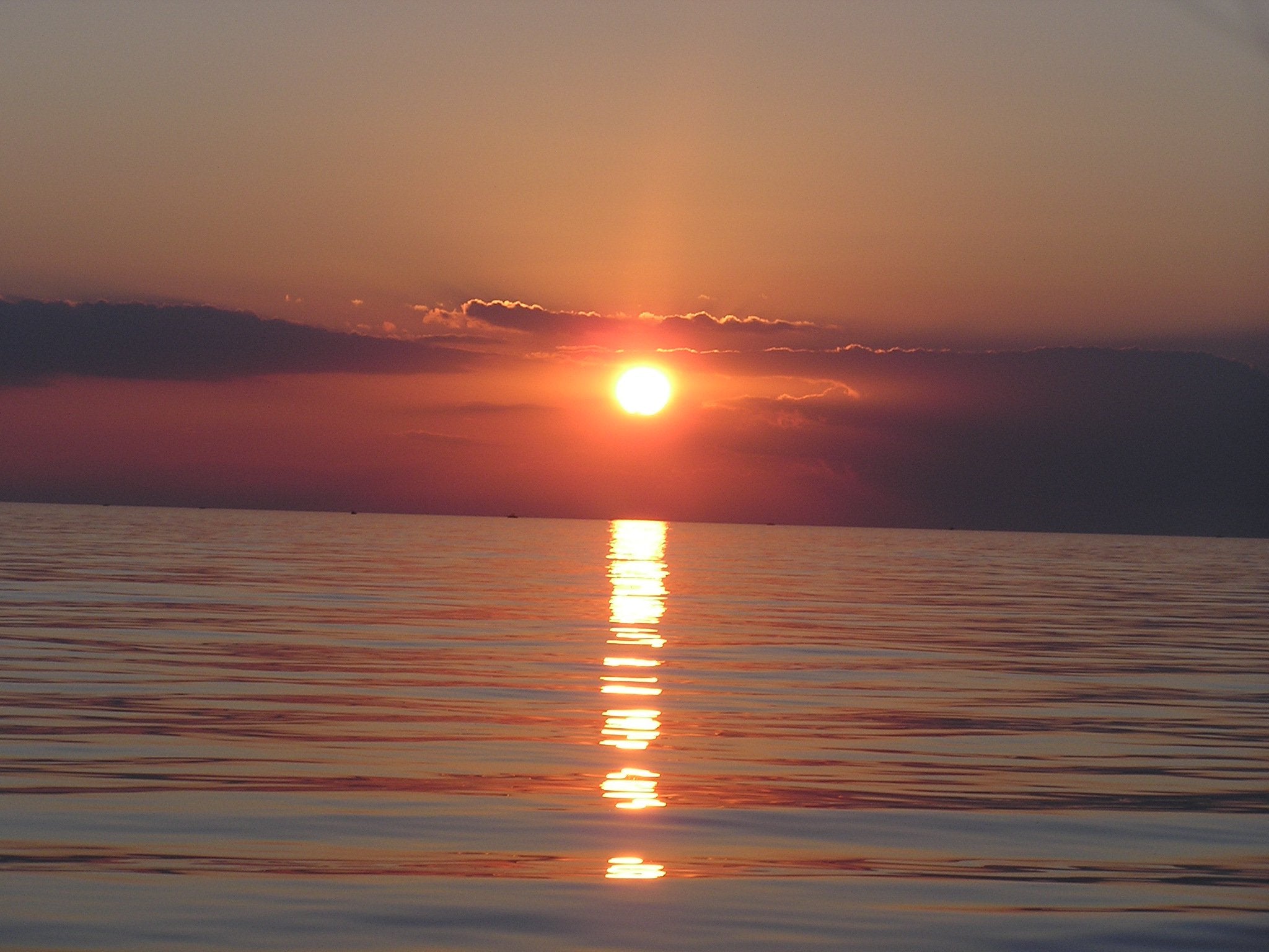 a photograph of a sunrise over a calm ocean